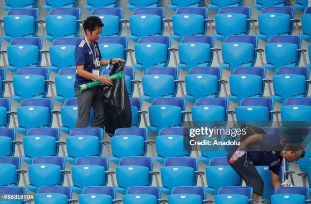 Fans clean the tribunes following the 2018 FIFA World Cup Russia Group H match between Japan and Poland at the Volgograd Stadium on June 28, 2018 in...