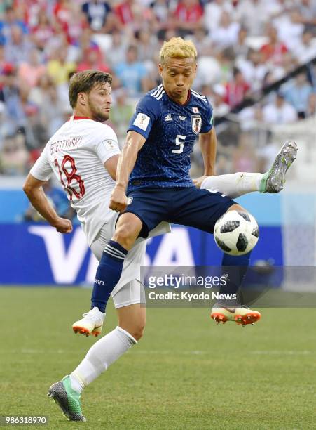 Yuto Nagatomo of Japan is marked by Bartosz Bereszynski of Poland during the second half of a World Cup Group H match between the two countries in...
