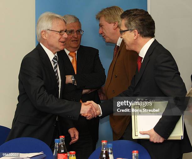 Reinhard Rauball , president of the German Football League shakes hands with Thomas de Maiziere , German Interior Minister prior to the round table...