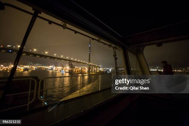 Crew members operate on the bridge of CMA CGM SA's Benjamin Franklin container ship as it enters Hong Kong Harbour in Hongkong, China, on Tuesday,...