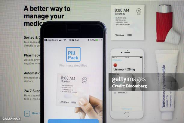 The PillPack Inc. Application and website is displayed on an Apple Inc. IPhone and laptop in an arranged photograph taken in Washington, D.C., U.S.,...