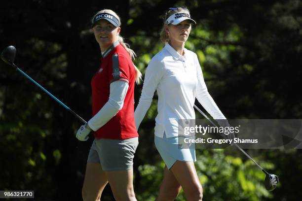 Charley Hull of England watches her tee shot on the second hole while Jessica Korda walks to tee off during the first round of the 2018 KPMG PGA...