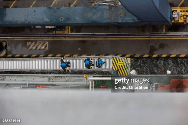 Crew members board the CMA CGM SA's Benjamin Franklin container ship as it is docked at Guangzhou Nansha Container Port in Guangzhou, China, on...