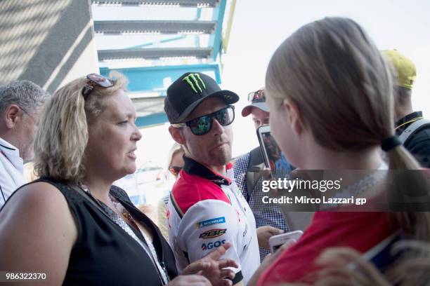 Cal Crutchlow of Great Britain and LCR Honda arrives and smiles at fans at the press conference pre-event during the MotoGP Netherlands - Previews on...