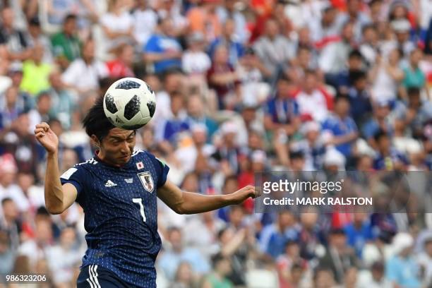 Japan's midfielder Gaku Shibasaki heads the ball during the Russia 2018 World Cup Group H football match between Japan and Poland at the Volgograd...