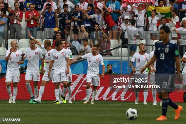 Poland's defender Jan Bednarek celebrates with teammates after scoring the opener during the Russia 2018 World Cup Group H football match between...