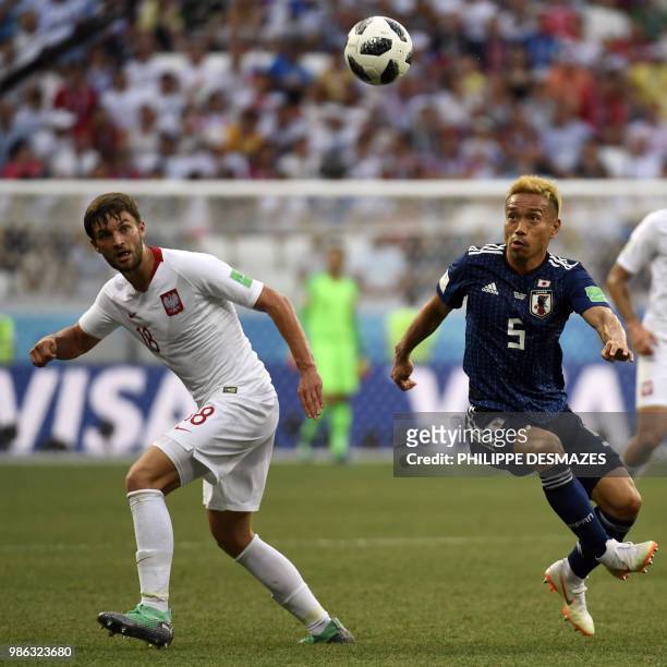Poland's defender Bartosz Bereszynski and Japan's defender Yuto Nagatomo eye the ball during the Russia 2018 World Cup Group H football match between...