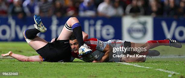 Daniel Carter of the Crusaders gets tackled by Richard Brown of the Force during the round 11 Super 14 match between the Western Force and the...