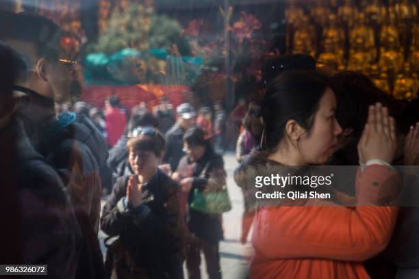 Worshipers make offerings of incense sticks at Longhua Temple in Shanghai, China, on Tuesday, Feb. 9, 2016.