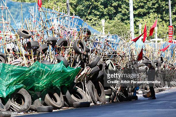 Thai policeman stand next to barricade of Red shirt anti-government supporters at Silom streel on April 23, 2010 in Bangkok, Thailand. Thai police...