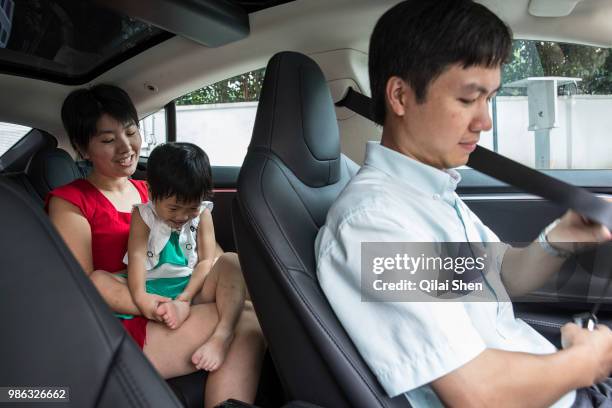 Husband and wife team Fan Yi and Zhang Jie with their daughter in Hangzhou, China on 07 September 2014.