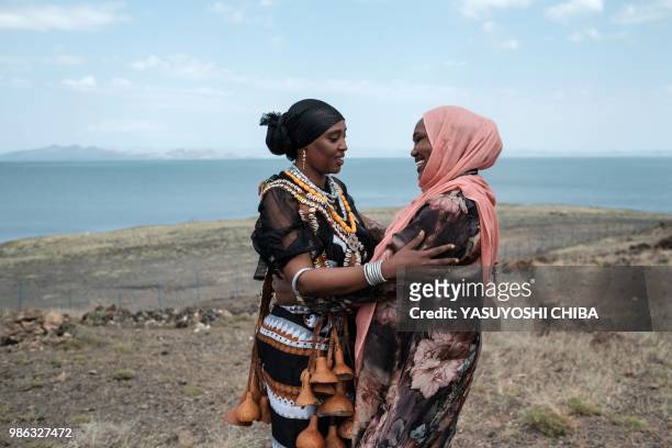 Marsabit County Governor's wife in Borana's tribal attire greets a woman by the Lake Turkana, the world's largest desert lake, in nothern Kenya on...