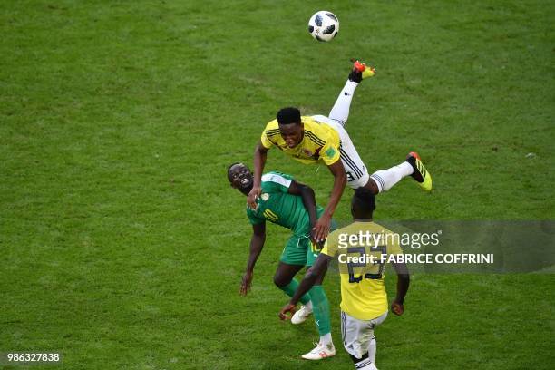 Colombia's defender Yerry Mina jumps for the ball with Senegal's forward Sadio Mane during the Russia 2018 World Cup Group H football match between...
