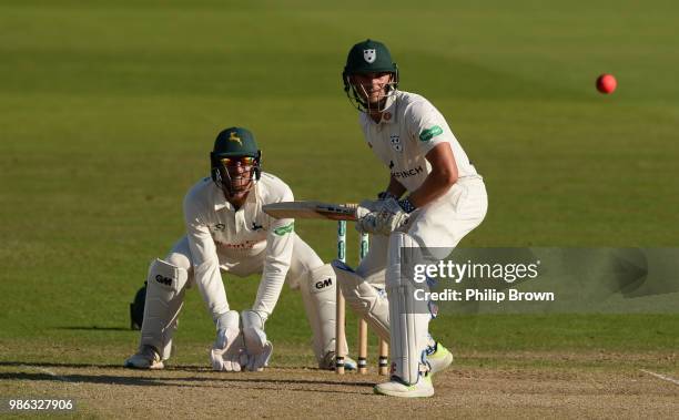 Joe Clarke of Worcestershire hits out watched by Riki Wessels of Nottinghamshire during the Specsavers County Championship Division One match between...