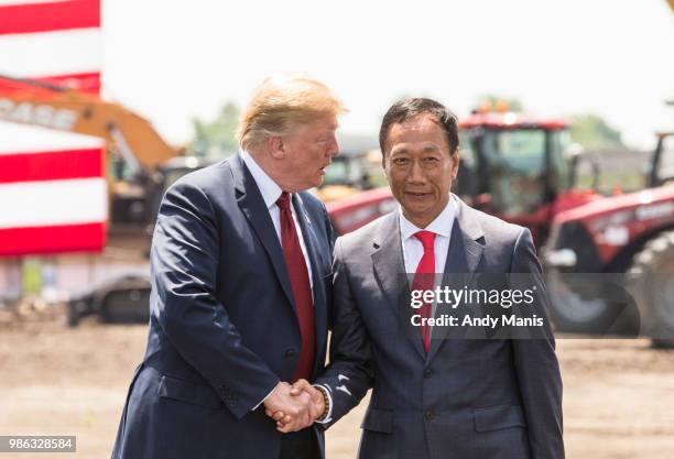 President Donald Trump shakes hands with Foxconn CEO Terry Gou at the groundbreaking for the Foxconn Technology Group computer screen plant on June...