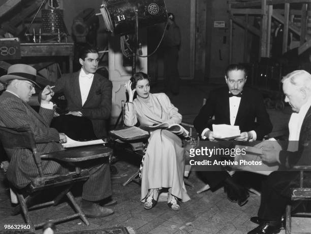 Actors Tyrone Power, Loretta Young, Edward H Griffing, Adolphe Menjou and Charles Winninger reading through scripts, circa 1937.