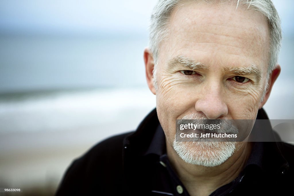A middle-aged man enjoys the North Carolina beach.