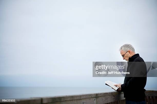 a middle-aged man enjoys the north carolina beach. - carolina beach stock pictures, royalty-free photos & images