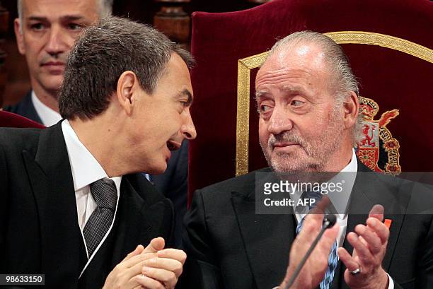 Spain's King Juan Carlos talks with Prime Minister Jose Luis Rodriguez Zapatero during the Miguel de Cervantes 2009 Prize ceremony at the University...