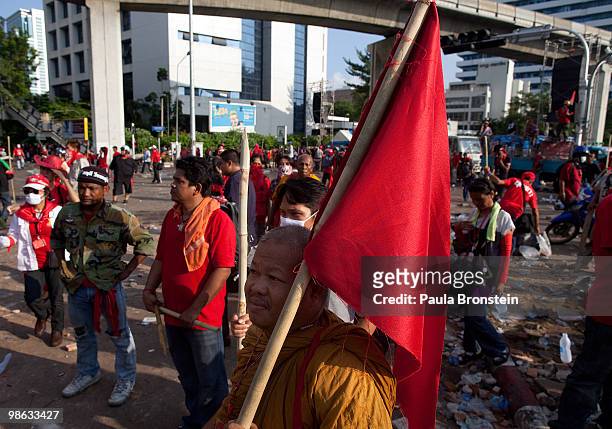Thai monk holds a red flag at the anti- government camp, as the tense standoff continues April 23, 2010 in Bangkok, Thailand. A series of coordinated...