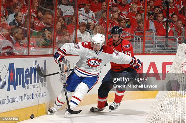 Marc-Andre Bergeron of the Montreal Canadiens trys to control the puck against Jaosn Chimara#25 of the Washington Capitals during Game One of the...