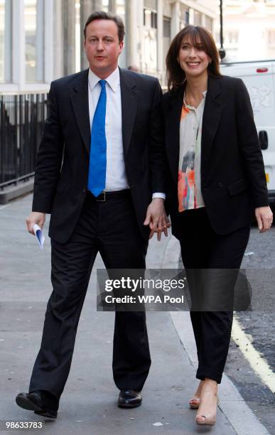 David Cameron, leader of Britain's Conservative party, left, and his wife Samantha, right, arrive at the Fashion Retail Academy on April 23, 2010 in...