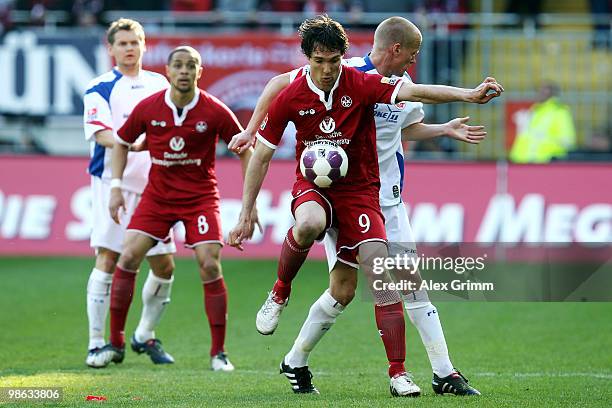 Srdjan Lakic of Kaiserslautern is challenged by Andreas Dahlen of Rostock during the Second Bundesliga match between 1. FC Kaiserslautern and Hansa...