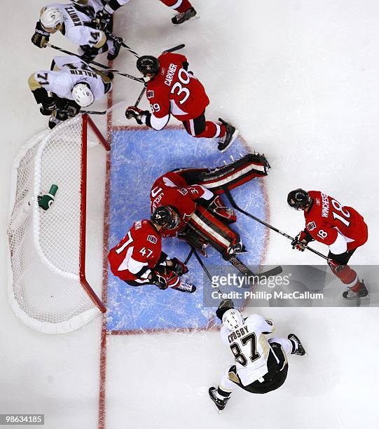 Goaltender Pascal Leclaire of the Ottawa Senators makes a save on Sidney Crosby of the Pittsburgh Penguins in Game 4 of the Eastern Conference...