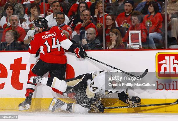 Matt Cooke of the Pittsburgh Penguins is checked to the ice by Chris Campoli of the Ottawa Senators in Game 4 of the Eastern Conference Quaterfinals...