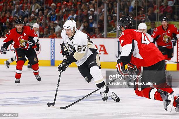 Sidney Crosby of the Pittsburgh Penguins skates with the puck against Chris Phillips of the Ottawa Senators in Game 4 of the Eastern Conference...