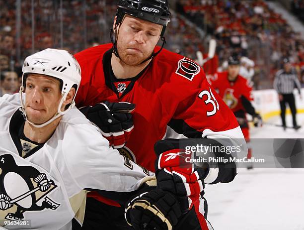 Matt Carkner of the Ottawa Senators is defended by Mark Eaton of the Pittsburgh Penguins in Game 4 of the Eastern Conference Quaterfinals during the...
