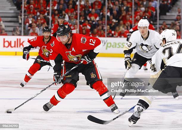 Mike Fisher of the Ottawa Senators shoots as Jay McKee of the Pittsburgh Penguins defends in Game 4 of the Eastern Conference Quaterfinals during the...
