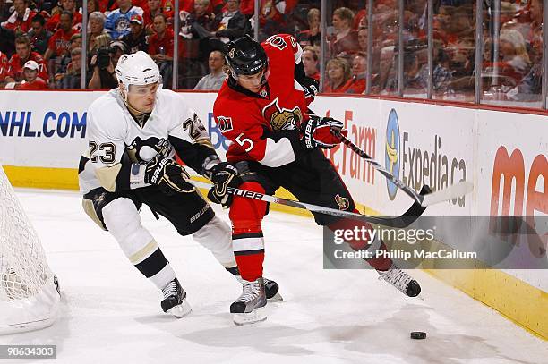 Erik Karlsson of the Ottawa Senators battles for the puck with Alexei Ponikarovsky of the Pittsburgh Penguins in Game 4 of the Eastern Conference...