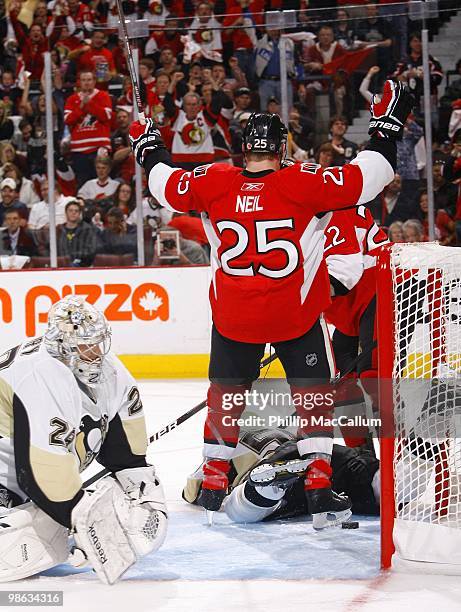 Dejected Marc-Andre Fleury of the Pittsburgh Penguins gets up from the ice as Chris Neil of the Ottawa Senators celebrates a goal in Game 4 of the...