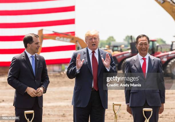 President Donald Trump speaks as Wisconsin Gov. Scott Walker and Foxconn CEO Terry Gou look on at the groundbreaking for the Foxconn Technology Group...