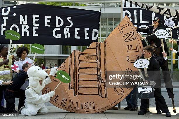 Activists dressed as bankers attempt to win a tug-of-war over half a cent in a stunt aimed to urge the G20 ministers to enact a Finacial Speculation...