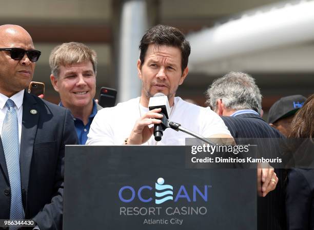 Mark Wahlberg speaks onstage at the Ocean Resort Casino opening weekend ribbon cutting ceremony with Atlantic City Mayor Frank Gilliam and Scott...