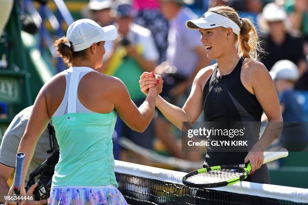 Denmark's Caroline Wozniacki shakes hands with Australia's Ashleigh Barty after their women's singles quarter final match at the ATP Nature Valley...