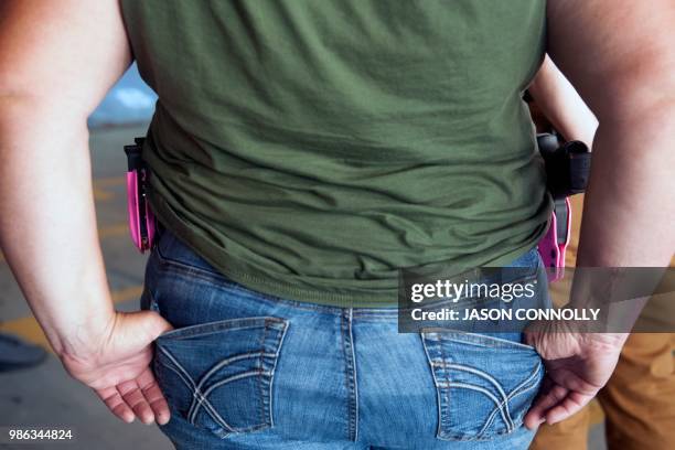 Trainee wearing a pink holster and magazine holder attends a three-day firearms course offered to school teachers and administrators by FASTER...