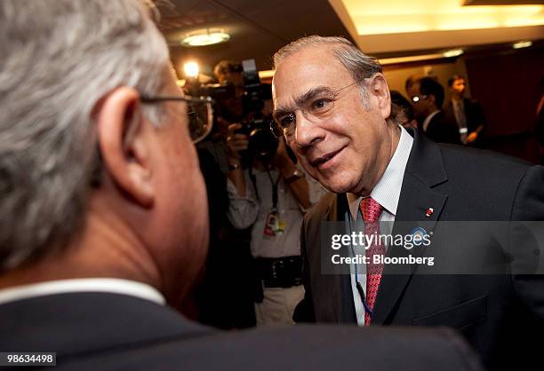 Angel Gurria, secretary-general of the Organization for Economic Cooperation and Development , right, talks to Wayne Swan, treasurer of Australia, at...