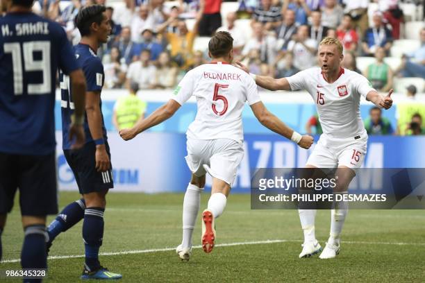 Poland's defender Jan Bednarek celebrates with Poland's defender Kamil Glik after scoring the opener during the Russia 2018 World Cup Group H...