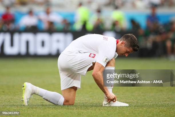 Robert Lewandowski of Poland ties his lace during the 2018 FIFA World Cup Russia group H match between Japan and Poland at Volgograd Arena on June...