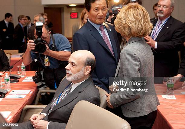 Ben S. Bernanke, chairman of the U.S. Federal Reserve, left, sits as Yoon Jeung-Hyun, South Korea's finance minister, center, greets Elena Salgado,...