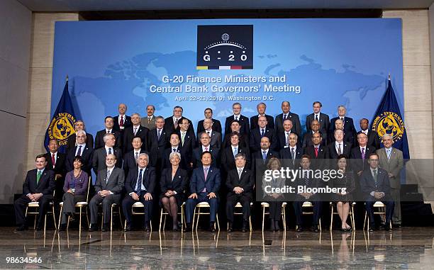 Finance ministers and central bank governors including James Flaherty, Canada's finance minister, front row left to right, Mercedes Marco del Pont,...
