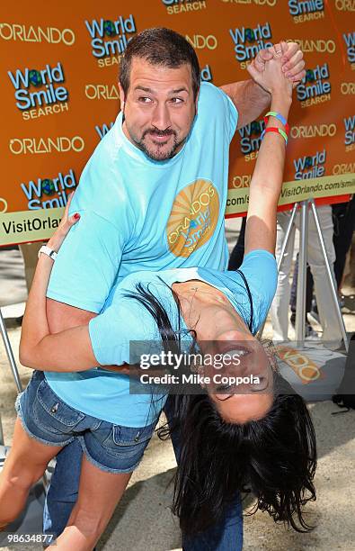 Singer/actor Joey Fatone dips television personality Melissa Rycroft at Smile Train's World Smile Search in Madison Square Park on April 23, 2010 in...