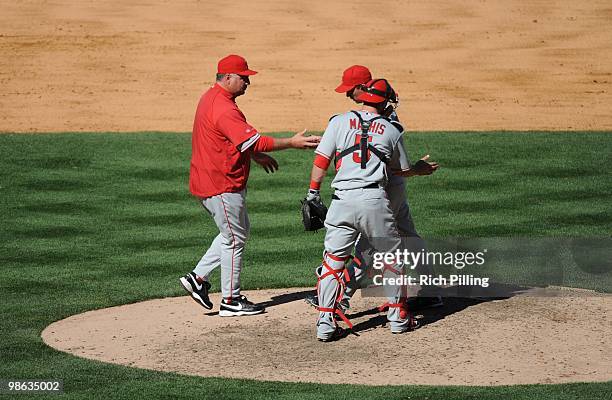 Mike Scioscia, manager of the Los Angeles Angels of Anaheim makes a pitching change during the game against the New York Yankees at Yankee Stadium in...