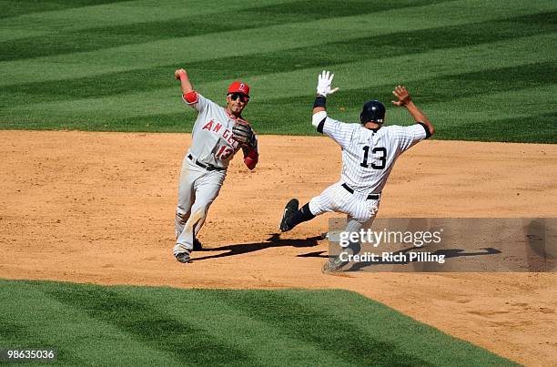 Maicer Izturis of the Los Angeles Angels of Anaheim throws the baseball to first base during the game against the New York Yankees at Yankee Stadium...