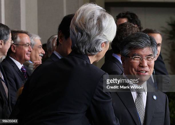 South Korean Central Bank Governor, Jung Su Kim , talks with France finance minister Christine Lagarde during a group photo at the International...