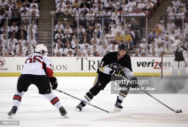 Jordan Staal of the Pittsburgh Penguins handles the puck in front of Erik Karlsson of the Ottawa Senators in Game Five of the Eastern Conference...