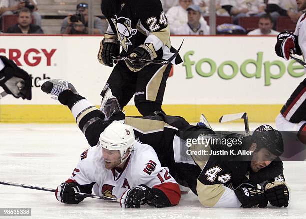 Mike Fisher of the Ottawa Senators and Brooks Orpik of the Pittsburgh Penguins get tired up after a hit in Game Five of the Eastern Conference...